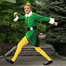 a man in a green elf costume is jumping