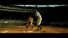 a baseball game is being played in front of a stadium that has a sign that says ' coca-cola ' on it