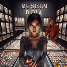 a woman stands in front of a sign that says " museum bola "