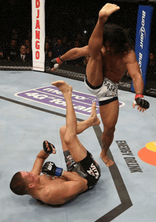 a fighter wearing shorts that say ufc is doing a submission