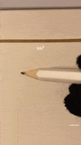 a person holding a pencil in front of a drawing that says ' us ' on it