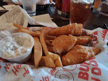 a basket of fish and french fries on a table