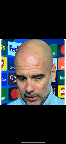 a bald man with a red spot on his head