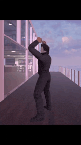 a man in a black suit is standing on a balcony