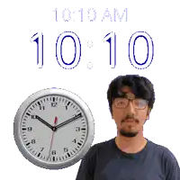 a man stands in front of a clock that says 10:10