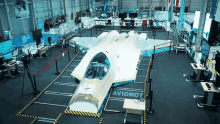 a fighter jet is sitting in a hangar with a sign that says avionot