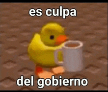 a yellow rubber duck is holding a white cup of coffee .