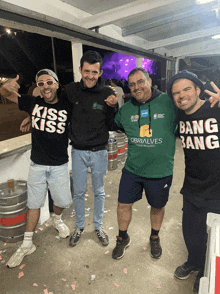 a man wearing a green shirt that says obrialves is standing next to two other men