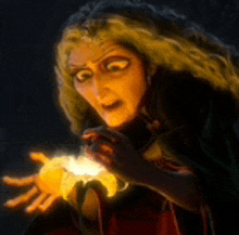 a woman with long hair is holding a light in her hand .