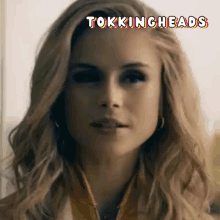 a close up of a woman 's face with the words tokingheads written above her