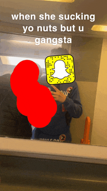 a man taking a selfie in front of a mirror with a snapchat icon in front of his face