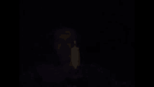 a person holding a candle in the dark