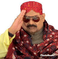 a man wearing sunglasses and a red turban is saluting in a photo taken with photoroom