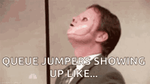 a man in a suit and tie with a scar on his face is saying `` queue jumpers showing up like ... ''