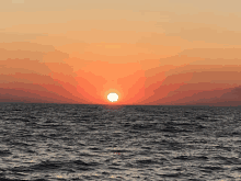 a sunset over the ocean with the sun setting