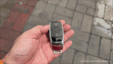a person is holding a mercedes car key
