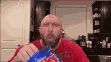 a bald man with a beard is eating a bag of chicken .