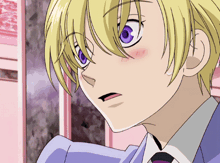 a boy with blonde hair and purple eyes is wearing a blue suit and tie