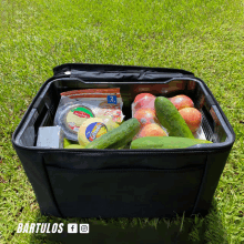 a cooler filled with fruits and vegetables including a bag of cheddar