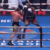 two boxers are fighting in a ring with the word everlast on the ropes