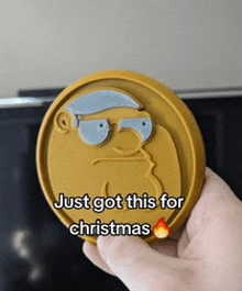 a person is holding a coin that says " just got this for christmas "