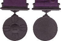 a black medal with a purple ribbon that says param vir chakra