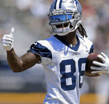 a football player wearing a cowboys jersey giving a thumbs up