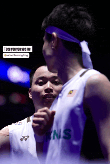 a man wearing a purple headband says " i see you you see me " on the bottom