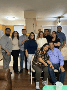 a group of people posing for a photo in a kitchen