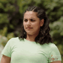 a woman in a green power rangers t-shirt