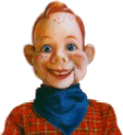 a close up of a puppet wearing a red plaid shirt and a blue scarf .