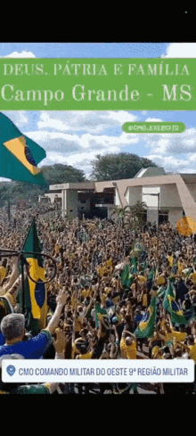 a crowd of people holding up flags in front of a building with the words deus patria e familia campo grande ms