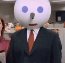 a man in a suit and tie with a jack in the box head