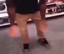 a man is dancing in a store in front of a shoe shelf .