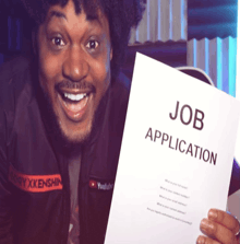 a man is holding a job application in his hands
