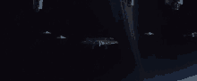 a group of spaceships are flying in the dark .