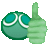 a green cartoon ball is giving a thumbs up .