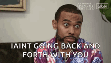 a man in a purple shirt is saying iaint going back and forth with you