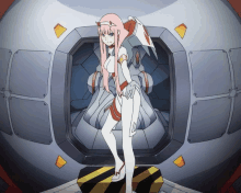 a girl with pink hair and horns is standing in front of a machine