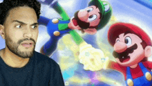 a man with a beard is standing in front of a mario and luigi poster .