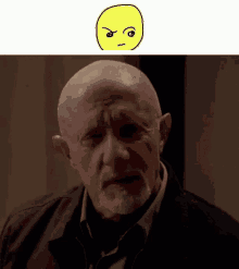 a bald man with a beard and a yellow smiley face