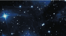 a cluster of stars in the night sky with a blue star in the middle