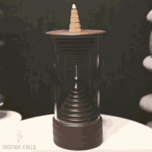 an incense burner that says incense falls on the bottom of it