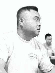 a man wearing a white salty crew shirt