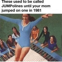 a woman in a blue leotard is jumping on a trampoline with a group of girls watching .