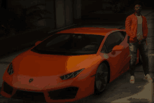 a man in an orange jacket stands in front of an orange car