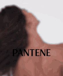 a blurred image of a woman 's back with pantene written on it