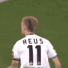 a soccer player wearing a white jersey with the number 11 on it