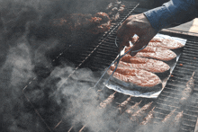 a person is grilling salmon on a foil covered grill