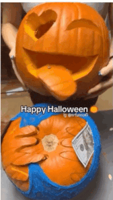a person is holding a carved pumpkin that says happy halloween on the bottom